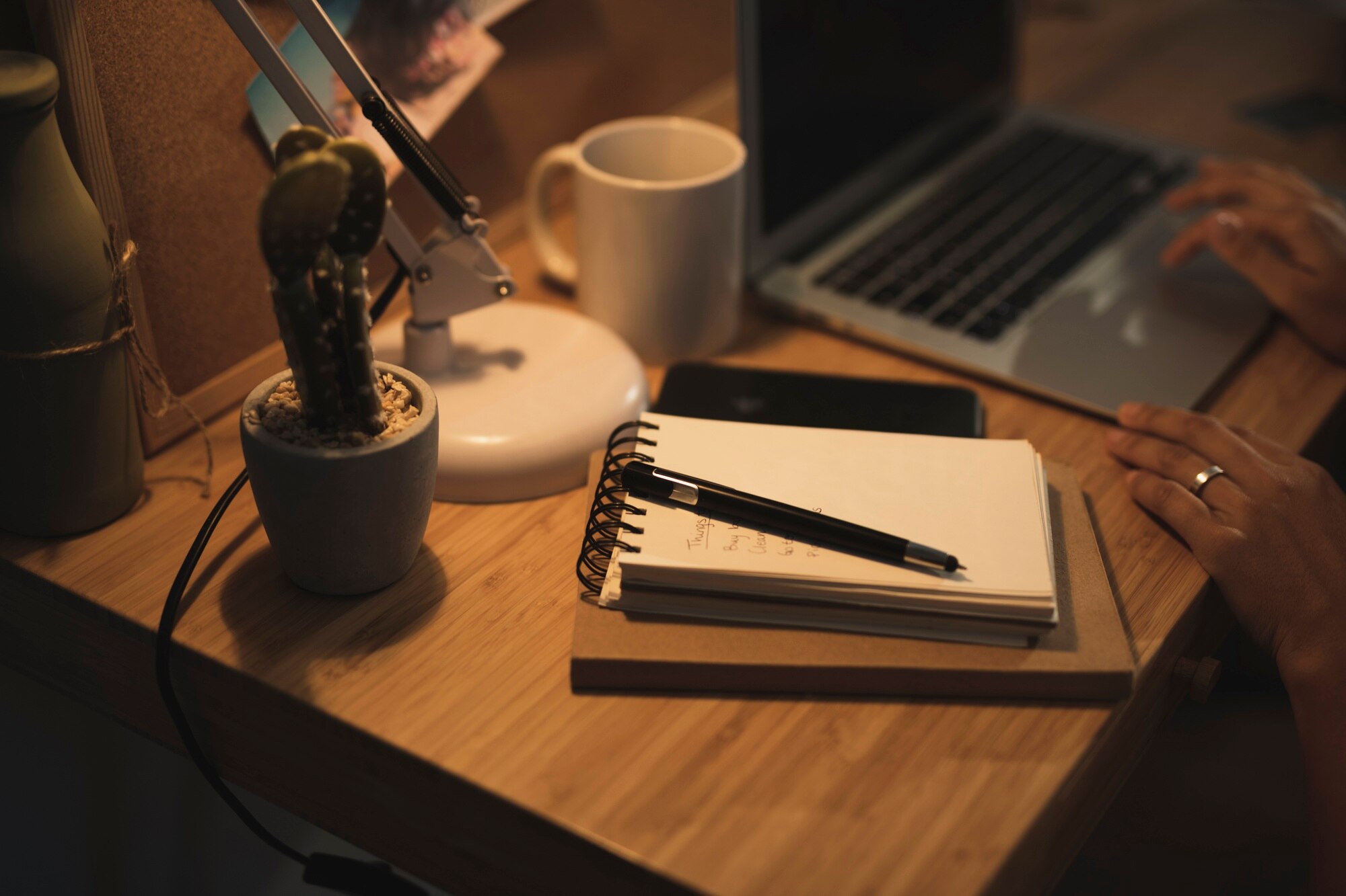 Quiet writing desk with notebook and warm light